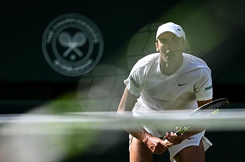 Britain's Oliver Tarvet reacts as he waits for the ball played by Spain's Carlos Alcaraz during their men's singles second round tennis match on the third day of the 2025 Wimbledon Championships at The All England Lawn Tennis and Croquet Club in Wimbledon, southwest London, on July 2, 2025.