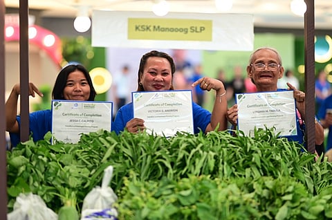 Recent graduates of the KSK Farming Program from Manaoag, Pangasinan showcase their certificates of completion together with the agricultural produce from their hands-on training experience.