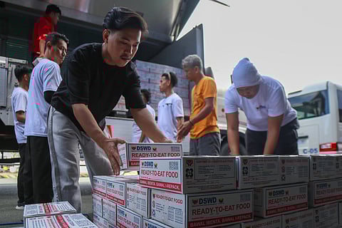 DEPARTMENT of Social Welfare and Development workers unload thousands of ready-to-eat food packs at the North Port Passenger Terminal in Manila.