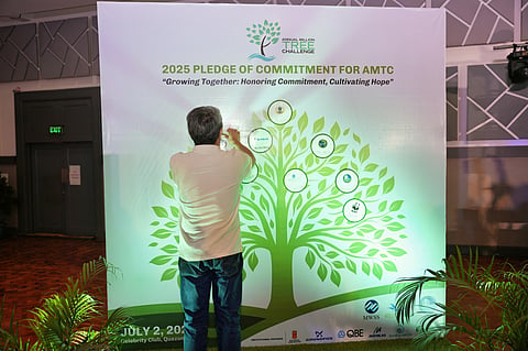 A SUPPORTER of the Annual Million Trees Challenge sticks his organization’s logo on the pledging board during the AMTC Recognition and Awarding ceremony on 2 July at the Celebrity Club in Quezon City.