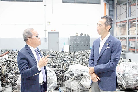 TOYOTA and Standard Insurance executives discuss vehicle recycling inside the dismantling site.