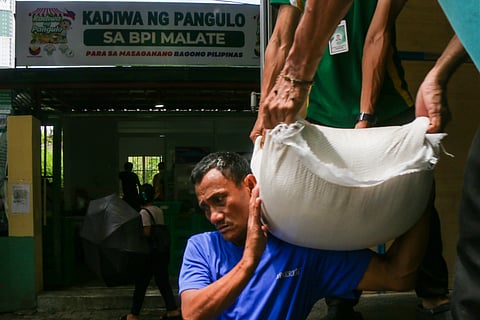 WORKERS unload sacks of rice at the Kadiwa ng Pangulo outlet on San Andres Street, Manila, on Monday. Priced at just P20 per kilo with a 10-kilo purchase cap, the rice is part of the ‘Benteng Bigas Meron Na! (BBM Na!)’ program for vulnerable sectors.