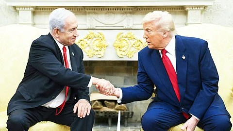 US President Donald Trump shakes hands with Israeli Prime Minister Benjamin Netanyahu during a meeting in the Oval Office of the White House in Washington, D.C.