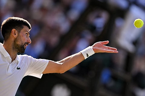 Serbia's Novak Djokovic serves to Italy's Flavio Cobolli during their men's singles quarter-final tennis match on the tenth day of the 2025 Wimbledon Championships at The All England Lawn Tennis and Croquet Club in Wimbledon, southwest London, on July 9, 2025.