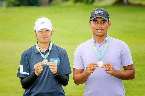 Adrian Bisera and Crista Minoza show off their medals after topping the 15-18 divisions of the ICTSI JPGT Junior Series at South Forbes Golf and Country Club on Friday in Davao City.