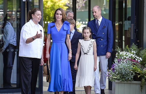 Britain's Catherine, Princess of Wales (front C), Britain's Princess Charlotte of Wales (front R), Britain's Prince William, Prince of Wales (rear r) are welcomed by member of the Committee of Management of The Championships Sally Ambrose (front L) upon their arrival to attend the men's singles final tennis match between Italy's Jannik Sinner and Spain's Carlos Alcaraz on the fourteenth day of the 2025 Wimbledon Championships at The All England Lawn Tennis and Croquet Club in Wimbledon, southwest London, on July 13, 2025.