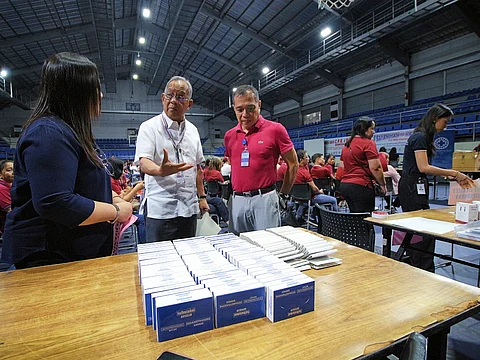 SBMA Chairman and Administrator Eduardo Jose L. Aliño talks to a Unilab official during the health caravan for Freeport stakeholders at the Subic Bay Gymnasium on July 17, 2025.