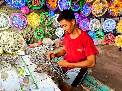 A parol maker crafts a parol at a shop in San Fernando, Pampanga.