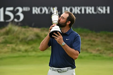 US golfer Scottie Scheffler kisses the Claret Jug, the trophy for the Champion golfer of the year after his victory in the 153rd Open Championship at Royal Portrush golf club in Northern Ireland on July 20, 2025. Scottie Scheffler romped to a magnificent four-shot victory to seal his first British Open title at Royal Portrush on Sunday, notching his fourth major success. The world number one eased to a three-under par final round of 68, finishing on 17-under for the tournament after shooting in the 60s on all four days.