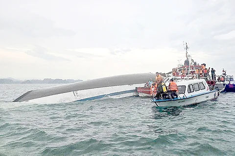 Rescuers personnel gather around a capsized tourist boat in the Ha Long Bay, Quang Ninh province.
