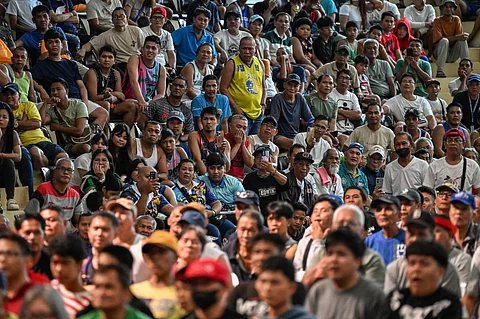 People watch a public screening of the WBC welterweight championship boxing match between Philippines’ Manny Pacquiao and US’ Mario Barrios, at Mandaluyong City in metro Manila on July 20, 2025.