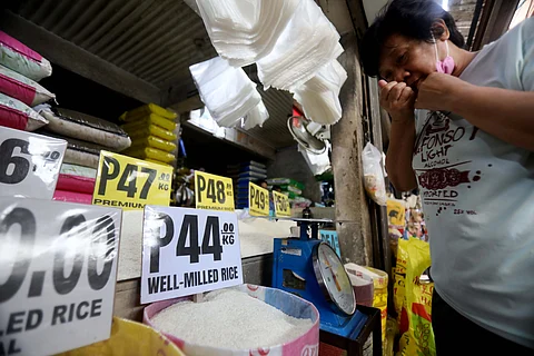 Checking A buyer smells rice at the Marikina Public Market to check its quality. A call has been made for the Department of Agriculture to establish floor farmgate prices for key commodities such as rice and corn.