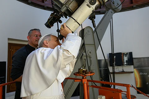 THIS handout photo taken and released on July 20, 2025 by the Vatican press office, Vatican Media shows Pope Leo XIV looking through a telescope during his visit at the Vatican Observatory, Specola in the summer papal estate in Castel Gandolfo, 40 km southeast of Rome. The newly elected Pope Leo XIV, revives a long-standing papal tradition paused under Francis, as Castel Gandolfo prepares to welcome a pope for the first time in over a decade.
