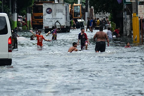 (FILES) After the deluge Streets turn into rivers and fences into trash traps as Metro Manila reels from days of relentless rain. Workers haul heaps of single-use plastic caught along Araneta Avenue in Quezon City, while residents in Valenzuela and Manila brave knee-deep floods. With the southwest monsoon showing no signs of letting up, the next three days promise more rain — and more hardship.