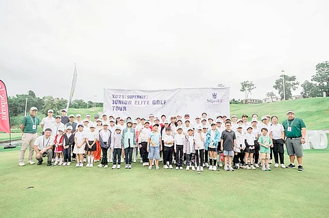 PARTICIPANTS in the kickoff leg of the Superkit Junior Elite Golf Tour brave the rains at the Vineyard Golf Club in Tanauan, Batangas on Saturday.