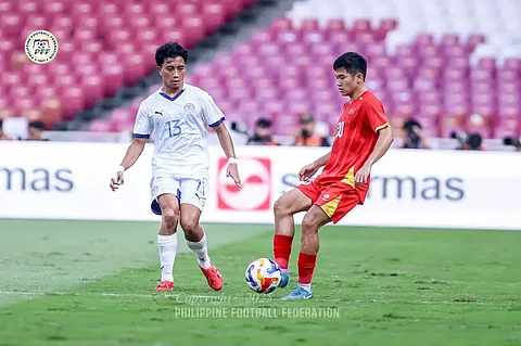 Zachary Taningco (left) of the Philippines makes his move against a Vietnamese defender in their Asean U23 Championships match on Friday in Jakarta. Vietnam won, 2-1.