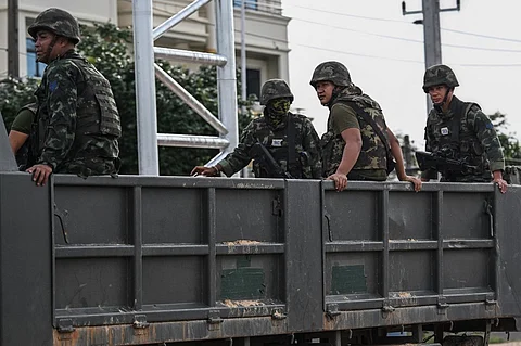 Royal Thai Army soldiers are transported on the back of an army truck in the Thai border province of Si Sa Ket on July 26, 2025. Thailand and Cambodia pounded each other with heavy artillery fire for a third day on July 26, as a border conflict that killed at least 33 people and displaced more than 150,000 from their homes spread across the frontier.