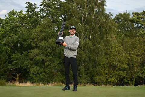 Chile's Joaquin Niemann celebrates with the trophy after winning the final day of the LIV Golf League event at the JCB Golf and Country Club in Rocester, central England, on July 27, 2025.