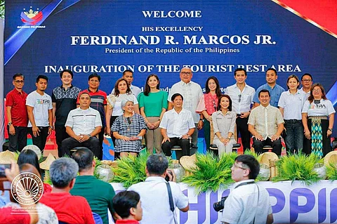 The first Tourist Rest Area (TRA) in the Ilocos Region was inaugurated by President Ferdinand R. Marcos, Jr. on May 17, 2024. With the Ilocos region known for its well-preserved ancestral and heritage houses, the building’s roofing was made of anahaw, a traditional material in the Ilocos Norte region, offering a distinctive look while serving a functional purpose as it helps prevent excessive heat buildup within the interior of the building, enhancing the comfort of visitors. It is located along the scenic Saud Bay in the town of Pagudpud.