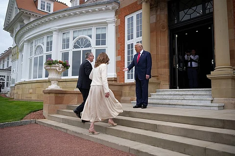 US President Donald Trump (R) greets Britain's Prime Minister Keir Starmer (L) and his wife Victoria Starmer (C) as they arrive for a meeting between the two leaders at the Trump Turnberry Golf Courses, in Turnberry south west Scotland on 28 July 2025.