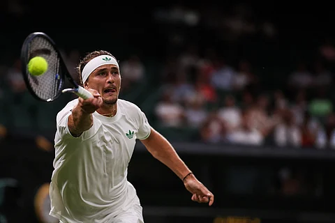 Germany's Alexander Zverev plays a forehand return to France's Arthur Rinderknech during their men's singles first round tennis match on the first day of the 2025 Wimbledon Championships at The All England Lawn Tennis and Croquet Club in Wimbledon, southwest London, on June 30, 2025.