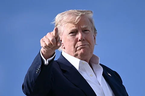 US President Donald Trump points as he boards Air Force One at RAF Lossiemouth, north-east Scotland on July 29, 2025 at the end of his trip to Scotland.