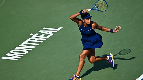 Naomi Osaka of Japan plays a forehand against Ariana Arseneault of Canada during their first round match on Day Two of the WTA 1000 National Bank Open at IGA Stadium on July 28, 2025 in Montreal, Quebec, Canada.