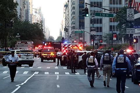 POLICE officers and emergency vehicles are seen in a street as police respond to a shooting incident in the Midtown Manhattan neighborhood of New York.