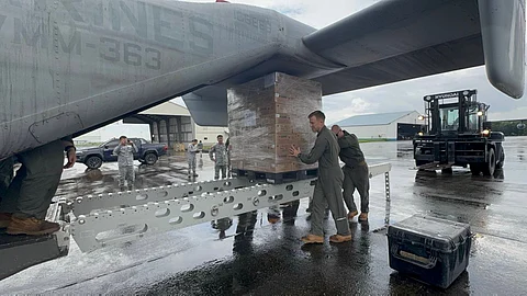 U.S. Marines and Philippine Airmen prepare the delivery of Department of Social Welfare and Development (DSWD) family food packs at Clark Air Base.