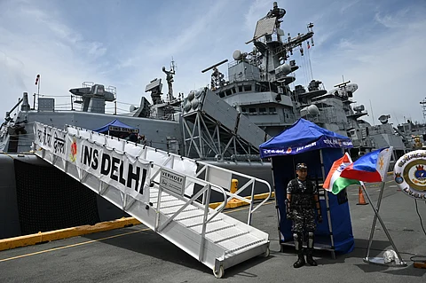 A member of the Armed Forces of the Philippines stands guard in front of the Indian Navy guided missile destroyer INS Delhi as it docked at the Port of Manila on Friday.