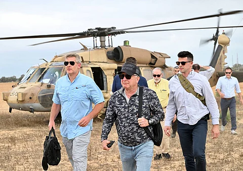 This handout photo from the US Embassy in Jerusalem shows White House special envoy to the Middle East Steve Witkoff (C, in hat) visiting a Gaza Humanitarian Foundation (GHF) food and aid distribution site inside the Gaza Strip on August 1, 2025.