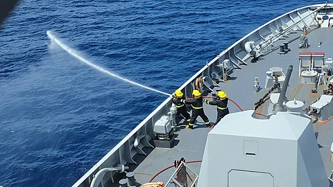 BRP Jose Rizal personnel train on using fire hoses during their joint maritime drills with the Indian Navy.