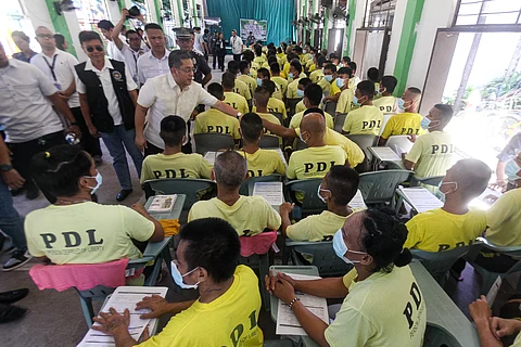COMMISSION on Elections chairperson George Garcia checks on the poll registration undertaken Monday for persons deprived of liberty at the Manila City Jail.