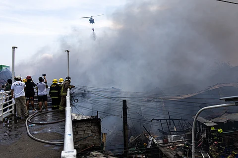 Firefighters race against time to douse the blaze that razed Aroma Compound residences in Tondo, Manila on Wednesday.