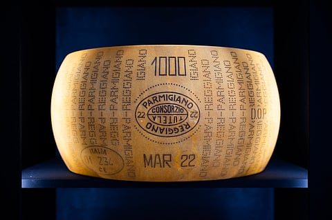 A form of Parmigiano Reggiano cheese is pictured at a stand of the Slow Food Salone del Gusto and Terra Madre in Turin on September 26, 2024. US President Donald Trump ordered the reimposition of tariffs on dozens of trading partners on July 31, 2025 -- his cornerstone strategy for reshaping global trade to benefit the US economy. However in a minor reprieve, the White House said the measures will take effect in a week, not on August 1 as previously expected.