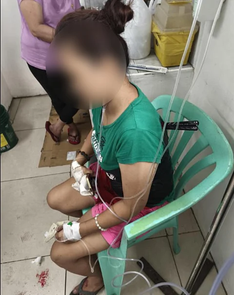 BALISONG knife lodged on the back of 31-year-old alias "Arlyn" after being stabbed by her husband, alias "Boy."