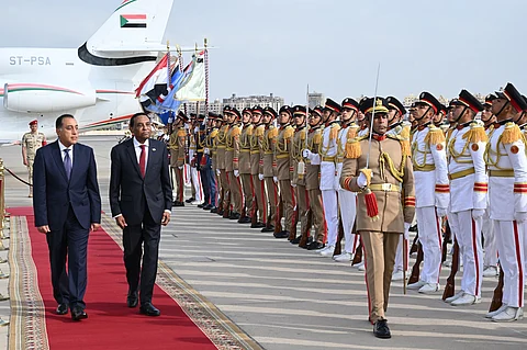 Egypt's Prime Minister Mostafa Madbouly (L) welcomes his counterpart from Sudan Kamil Idris upon his arrival at the Cairo International airport in Egypt's capital on August 7, 2025.
Sudan's army-aligned prime minister arrived in Cairo on August 7 morning, for his first official foreign visit since assuming office in May, as his country remains gripped by a brutal war, now in its third year.