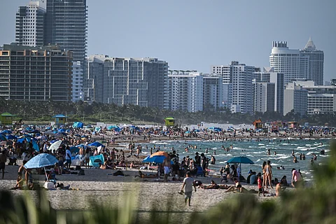PEOPLE enjoy the beach as the region is under an extreme heat warning in Miami Beach, Florida, on July 25, 2025.