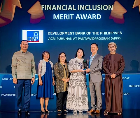 DBP Senior Vice President Ronaldo U. Tepora (second from right) and Senior Vice President Catherine T. Magana (third from right) receive the Merit Award for Financial Inclusion conferred to DBP for its participation in DA’s Agri-Puhunan at Pantawid Program (APP) during the 48th ADFIAP Annual Meeting in Muscat, Oman. Also in photo are (from left): Agricultural and Rural Development Bank Chief Executive Officer Dr. KAO Thach, DBP First Vice President Atty. Ma. Cristina C. Malab, DBP Senior Vice President Soraya F. Adiong and Development Bank in Sultanate of Oman Chief Executive Officer Mr. Hussain Al Lawati.