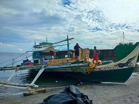The crew from the motorized fishing vessel that was intercepted by members of the Western Mindanao Naval Command for carrying P16.4 million worth of smuggled cigarettes in the waters of Basilan are waiting for orders to unload the contraband.