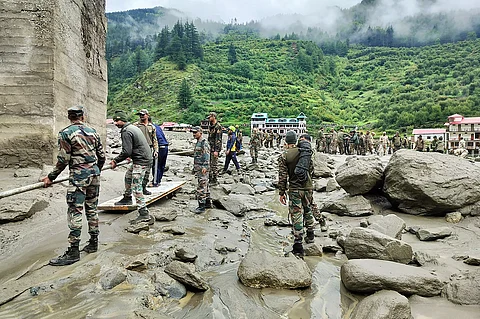 SECURITY and relief personnel preparing to build a crossing across a stream of dense sludge and rocks during a search and rescue operation, a day after a cloudburst caused a massive mudslide and flash floods in India’s Uttarakhand state.