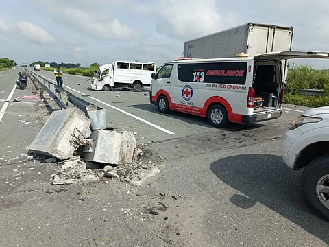 An ambulance from the Philippine Red Cross responds to a road accident involving an L300 mini-truck along the Central Luzon Expressway in La Paz, Tarlac. The incident left five dead and nine injured.