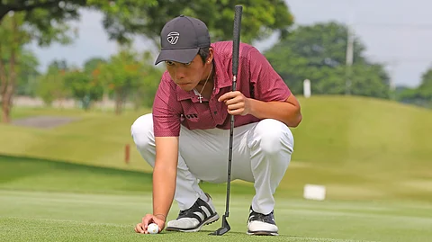 ZACHARY Villaroman reads the green en route to winning the 15-18 division of the ICTSI Pradera Verde Junior PGT Championship on Thursday.