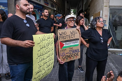Israelis lift placards against the war in Gaza during a rally in front of Tel Aviv's US consulate on July 29, 2025. Gaza is slipping into famine, the UN aid agencies warned on July 29, as the health ministry in the Hamas-run territory said the death toll in the nearly 22-month war had surpassed 60,000.