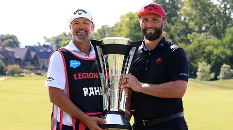 WESTFIELD, INDIANA - AUGUST 17: Jon Rahm of Legion XIII poses with the LIV golf season individual trophy and caddie, Adam Hayes, on day three of LIV Golf Indianapolis at The Club at Chatham Hills on August 17, 2025 in Westfield, Indiana.