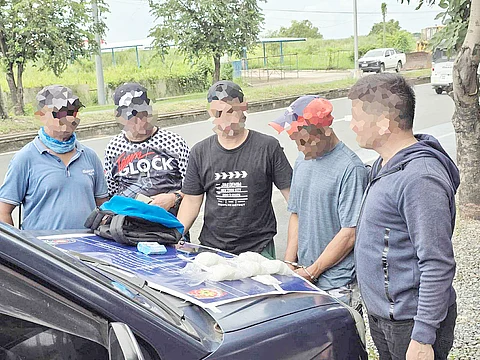 Operatives from the Balanga City Police Office’s Drug Enforcement Unit inspect the P6.8 million worth of suspected shabu seized from a suspect following a buy-bust operation on Thursday.
