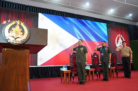 Lt. Gen. Ferdinand T. Barandon PA, AIC Commander; General Romeo S. Brawner Jr., AFP Chief of Staff; and Maj. Gen. Simplitius G. Adecer PN (M), AIC Deputy Commander salute during the singing of the national anthem at the 1st AIC Founding Anniversary held in Camp Aguinaldo, Quezon City on August 20, 2025.