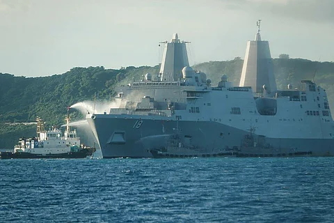 SMOKE comes out from the United States Navy vessel USS New Orleans as water is sprayed (left) to help put out the fire, off the coast near White Beach on the Japanese southern island of Okinawa.