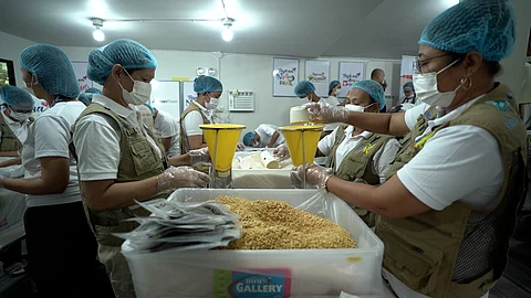 Volunteers from Prime Infra Foundation, Ahunan Power and Rise Against Hunger Philippines pack rice-soy meals for distribution to Grades 1 to 6 students of Saray Elementary School in Pakil, Laguna.