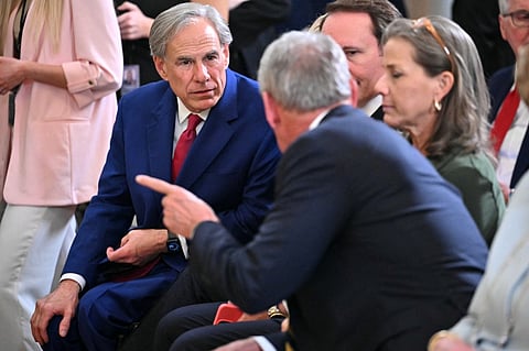 Texas Governor Gregg Abbott (L) attends an Education event and signing of executive orders by US President Donald Trump in the East Room of the White house in Washington, DC, March 20, 2025. US President Donald Trump will sign an order March 20, 2025 to start dismantling the Department of Education, fulfilling an election campaign pledge and a long-held dream of American conservatives. By law, the Education Department -- created in 1979 -- cannot be shuttered without the approval of Congress, and Republicans do not have the votes to push that through.